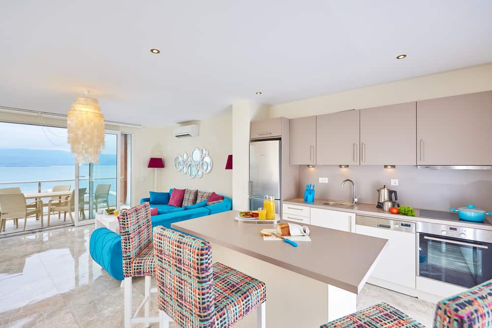 This is a beach style kitchen design with splashes of bright colors.