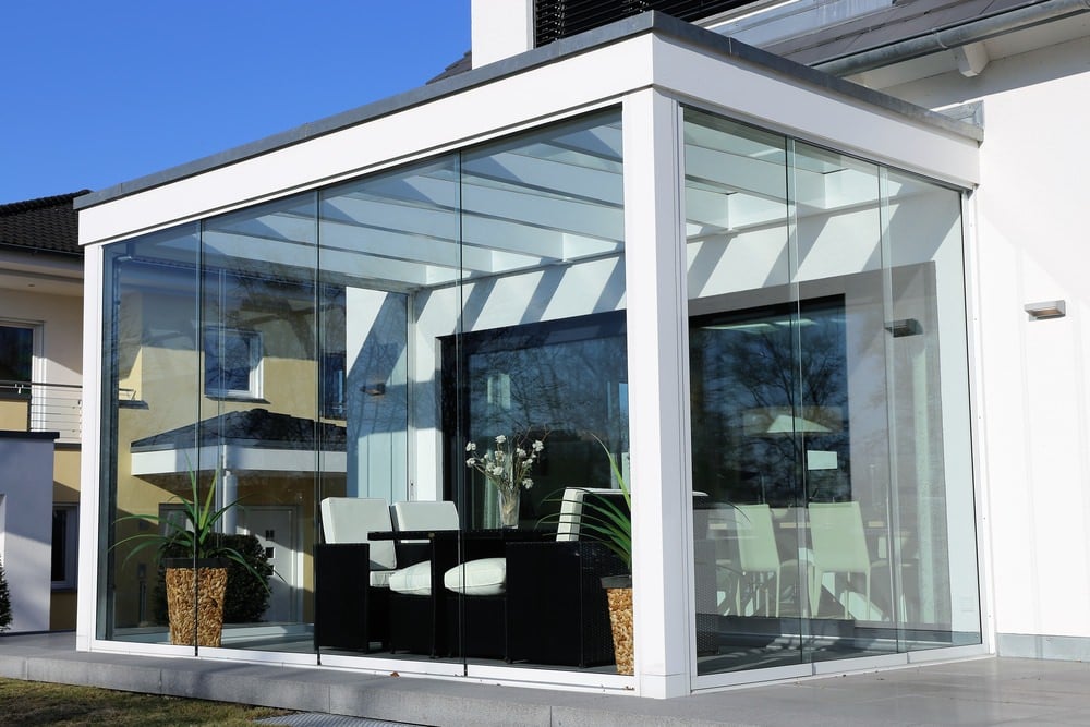 Sunroom with black and white furniture, and a minimal touch of modernity.