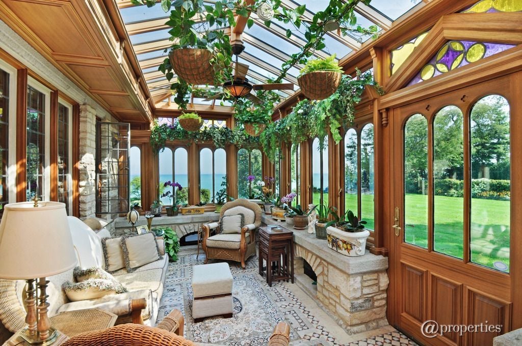 This tropical sunroom looks like a mini mansion dominated with fresh plants.
